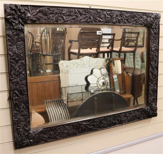 An oak frame wall mirror, W.111cm